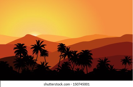 Golden sunset in the mountains with palm forest in the foreground