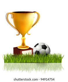 Golden trophy with soccer ball in the grass