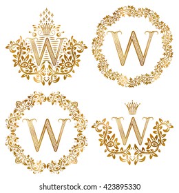Golden W letter vintage monograms set. Heraldic coats of arms and round frames.