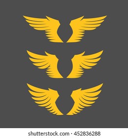 Golden wing silhouettes set. Different forms. Isolated on gray background. Design elements. Vector illustration.