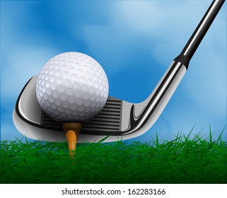 Golf ball and club in front of grass