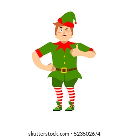 Good Christmas elf winks and thumbs up. Sign all is well. Cute joyful helper of Santa Claus. Happy little man in green suit. XMAS character for new year
