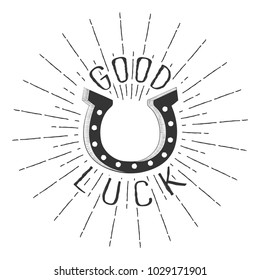 Good luck monochrome text lettering with horseshoe and rays of burst. Isolated on white background. Vector illustration.