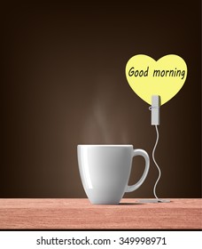 good morning in yellow  heart note with hot drink on wood table