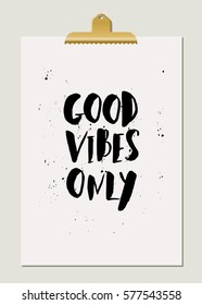 Good Vibes Only - inspirational quote poster design. Hand lettered text in black on cream paper with golden clip.