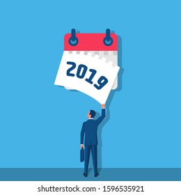 Goodbye 2019. A businessman tears off a calendar sheet of the outgoing year. Parting with coming year. Vector illustration flat design. Isolated on white background.