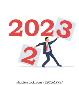 Goodbye 2022. Change year. Businessman tears off a sheet with 2 and sets the new year 2023. Vector illustration flat design. Isolated on white background.