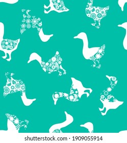 Goose with floral pattern seamless pattern on green background. Monochrome repeated bird print. Geese repeated ornament. Duck silhouette endless background