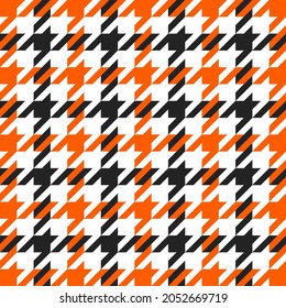 Goose foot. Halloween Pattern of crow's feet in orange, black and white cage. Glen plaid. Houndstooth tartan tweed. Dogs tooth. Scottish cage. Seamless fabric texture. Vector illustration