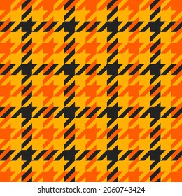 Goose foot. Halloween Pattern of crow's feet in orange, black and yellow cage. Glen plaid. Houndstooth tartan tweed. Dogs tooth. Scottish cage. Seamless fabric texture. Vector illustration