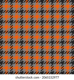 Goose foot. Halloween Pattern of crow's feet in orange, black and gray cage. Glen plaid. Houndstooth tartan tweed. Dogs tooth. Scottish cage. Seamless fabric texture. Vector illustration