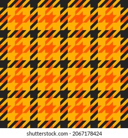 Goose foot. Halloween Pattern of crow's feet in orange, black and yellow cage. Glen plaid. Houndstooth tartan tweed. Dogs tooth. Scottish cage. Seamless fabric texture. Vector illustration
