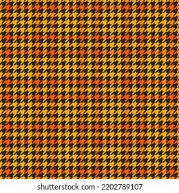 Goose foot. Halloween Pattern of crow's feet in orange, black and yellow cage. Glen plaid. Houndstooth tartan tweed. Dogs tooth. Scottish cage. Seamless fabric texture. Vector illustration