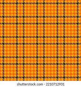 Goose foot. Halloween Pattern of crow's feet in orange, black and yellow cage. Glen plaid. Houndstooth tartan tweed. Dogs tooth. Scottish cage. Seamless fabric texture. Vector illustration