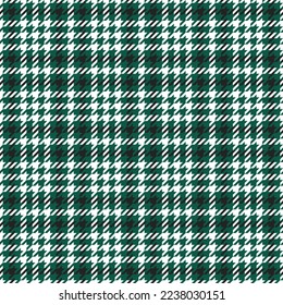 Goose foot. Pattern of crow's feet in black, green, white cage. Glen plaid. Houndstooth tartan tweed. Dogs tooth. Scottish checkered background. Seamless fabric texture. Vector illustration