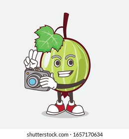 Gooseberry cartoon mascot character as photographer in action with a camera