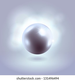 Gorgeous blue spherical pearl bead hanging over warm pink background