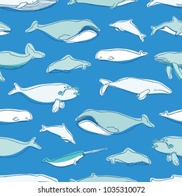 Gorgeous seamless pattern with various aquatic marine mammals hand drawn on blue background - whales, narwhal, dolphin, cachalot. Vector illustration for textile print, wrapping paper, backdrop.