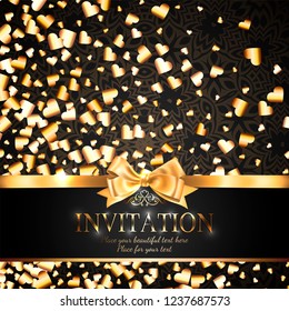 Gorgeous and shiny invitation card or banner with gold ribbon bow and sparkling golden hart-shaped glitter on black background with delicate pattern