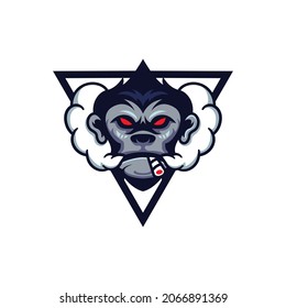 The gorilla mascot is smoking. Gorilla head smoking isolated on white background. Esport logo.