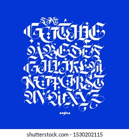 Gothic, English alphabet written in chalk. Vector font for tattoo and commercial purposes. Elements isolated on a blue background. Medieval latin letters are kept separately.