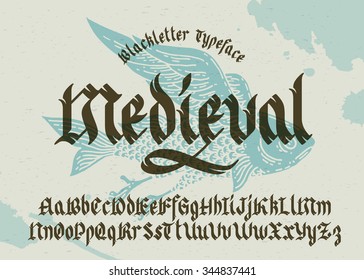 Gothic medieval typeface. Black-letter fracture font with flying fish illustration.