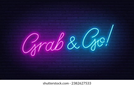 Grab and Go neon sign on brick wall background.