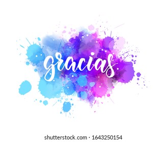 Gracias - Thank you in Spanish language. Handwritten modern calligraphy lettering text on multicolored watercolor paint splash background.