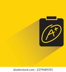 grade A result in clipboard with shadow on yellow background