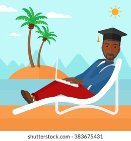 Graduate lying on chaise lounge with laptop.