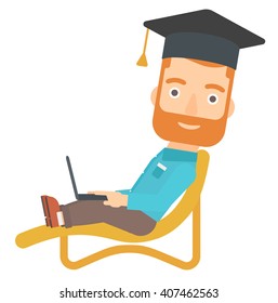 Graduate lying on chaise lounge with laptop.