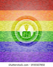 graduated icon inside emblem on mosaic background with the colors of the LGBT flag. 