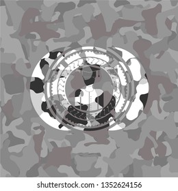 graduated icon inside grey camouflaged emblem
