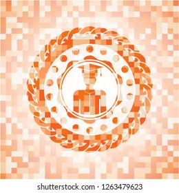 graduated icon inside orange mosaic emblem