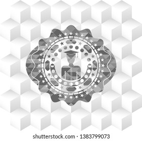 graduated icon inside retro style grey emblem with geometric cube white background