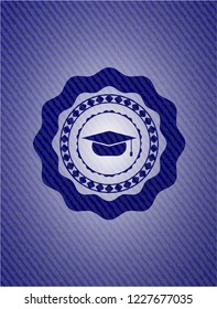 graduation cap icon inside badge with denim background