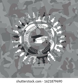 graduation cap icon inside grey camo emblem