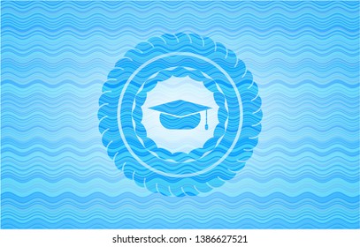 graduation cap icon inside light blue water wave emblem.