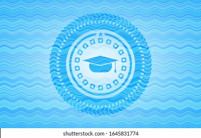 graduation cap icon inside light blue water wave style emblem.