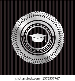 graduation cap icon inside silvery emblem or badge