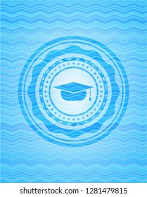 graduation cap icon inside water emblem.