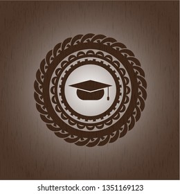 graduation cap icon inside wood emblem