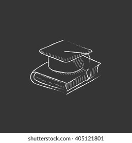 Graduation cap laying on book. Drawn in chalk icon.