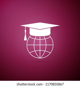 Graduation cap on globe icon isolated on purple background. World education symbol. Online learning or e-learning concept. Flat design. Vector Illustration