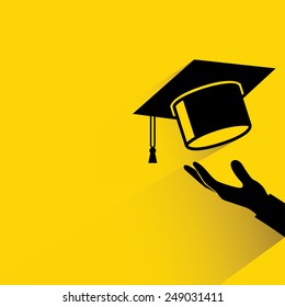 graduation cap thrown in the air, yellow background