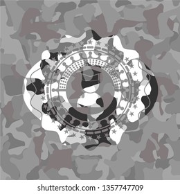 graduation icon inside grey camo emblem