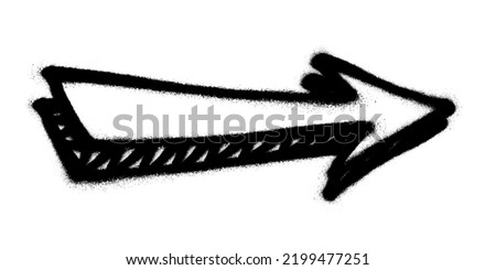 Graffiti arrow with overspray in black over white.
