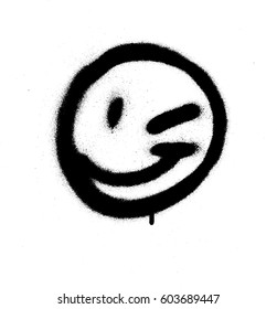 Graffiti emoticon wink face sprayed in black on white