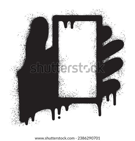 Graffiti of a hand holding a cellphone with black spray paint,