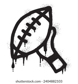 Graffiti of hands holding an American football ball with black spray paint